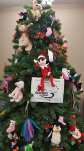 Eddie the Elf climbing a Christmas tree